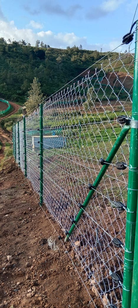 Angled outrigger arm carrying the live wires above the mesh line
