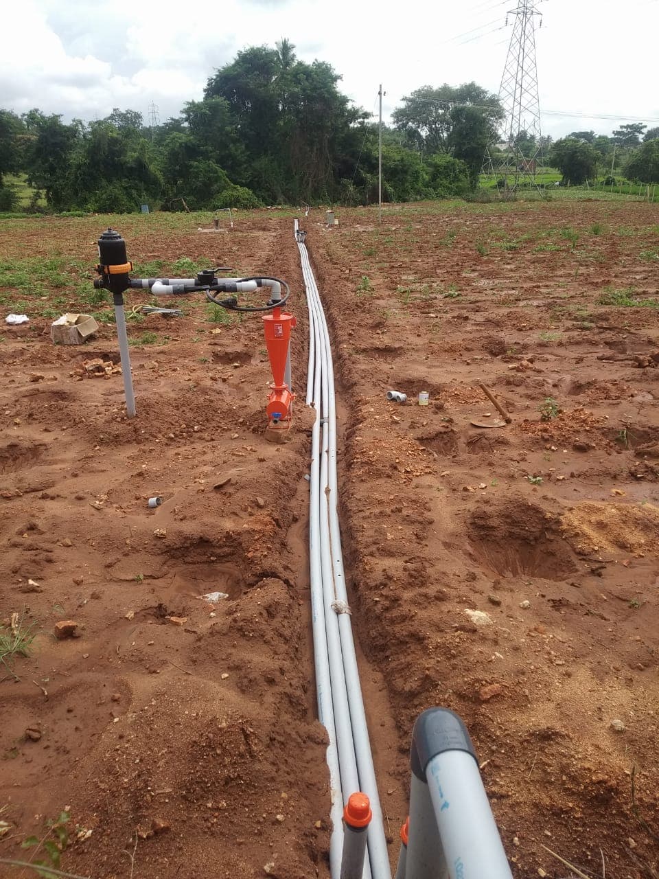 Filtration unit and mains trenched across a field under installation